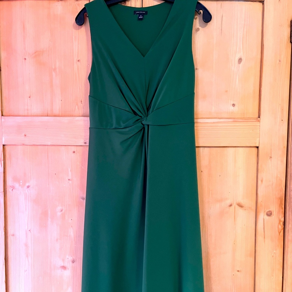 Green jersey dress with twist detail at waist. Size XS